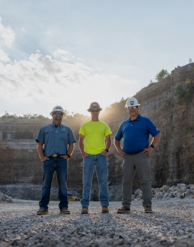 Construction workers standing side by side in quarry