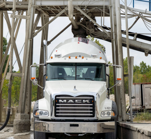 Concrete mixer trucks parked at a construction plant.